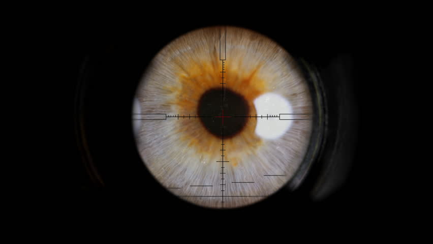 A sniper looking through the scope of his weapon.