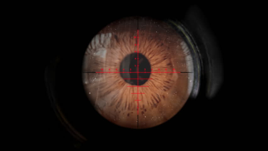 A sniper looking through the scope of his weapon. 