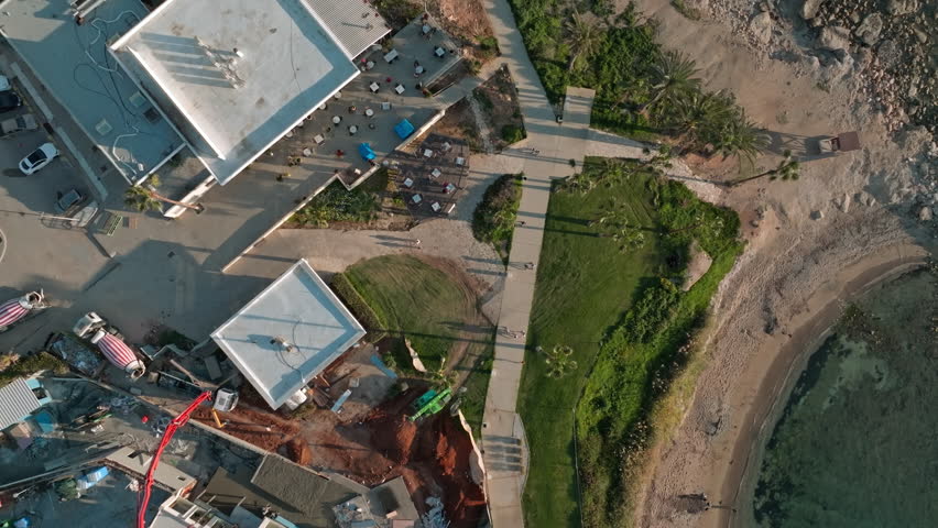 Aerial view tourist coastline with resorts in Paphos, Cyprus. Coastal rocky line of the sea with beaches in a tourist town on an island. High quality 4k footage