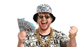 Crazy millionaire with golden teeth and dollars symbols on clothing holding money in hands, portrait. Happy rich man rejoicing of his wealth, mad about money, eccentric male person, financial success - Powered by Shutterstock - Get 15% off with code: PIKWIZARD15
