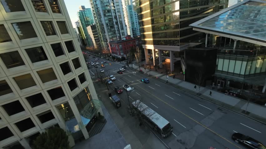 Flight between skyscrapers along the street in Downtown of Vancouver
