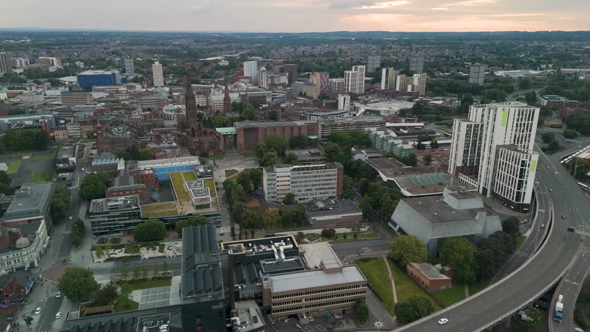 Aerial view of Coventry cityscape at dusk, featuring iconic cathedral and modern architecture