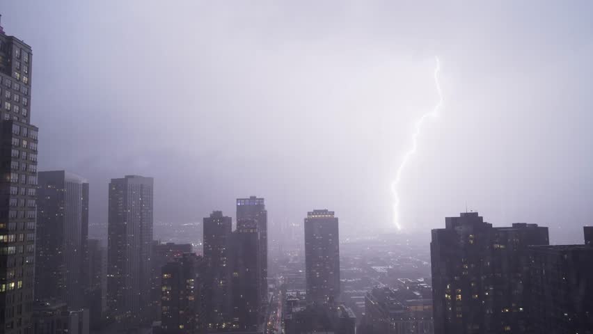 A dramatic scene unfolds as a bolt of lightning illuminates the city skyline during a storm, showcasing natures power