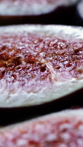 Fresh sliced fig with a dark background.