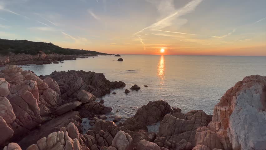 A beautiful view of Conca del Tramonto at sunrise with calm sea in Sardinia, Italy