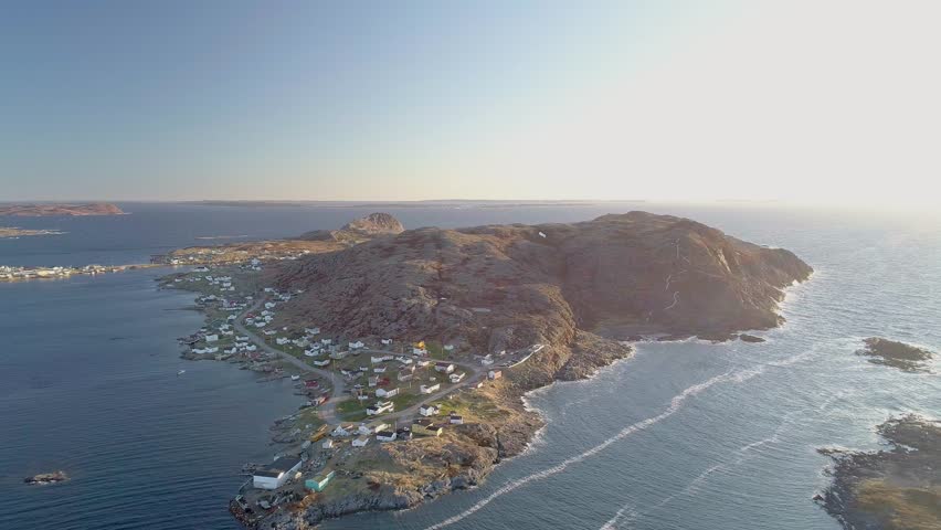 A drone footage over landscape of Fogo Island in Cape Verde by the water at sunset