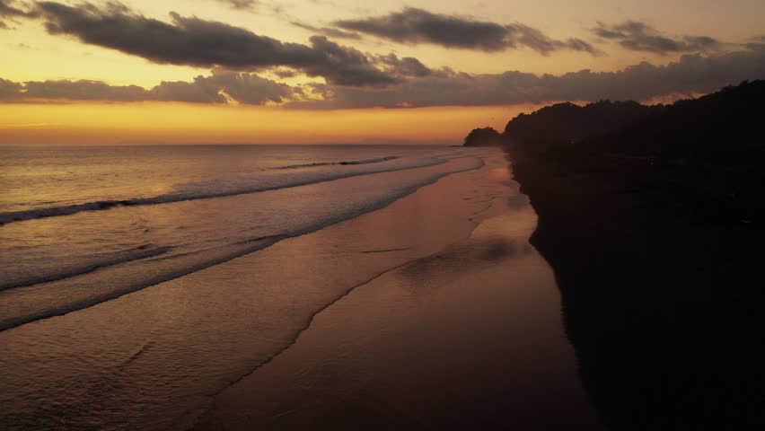 A beautiful golden sunset over Hermosa Beach in Costa Rica