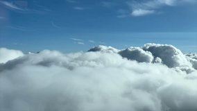 Immersive pilot POV flying through a sunny and blue sky with some white and grey cumulus clouds. Shot from an airplane cockpit. 4K 60FPS - Powered by Shutterstock - Get 15% off with code: PIKWIZARD15
