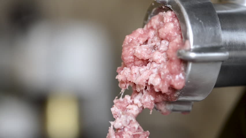 The process of grinding meat in a meat grinder at home .