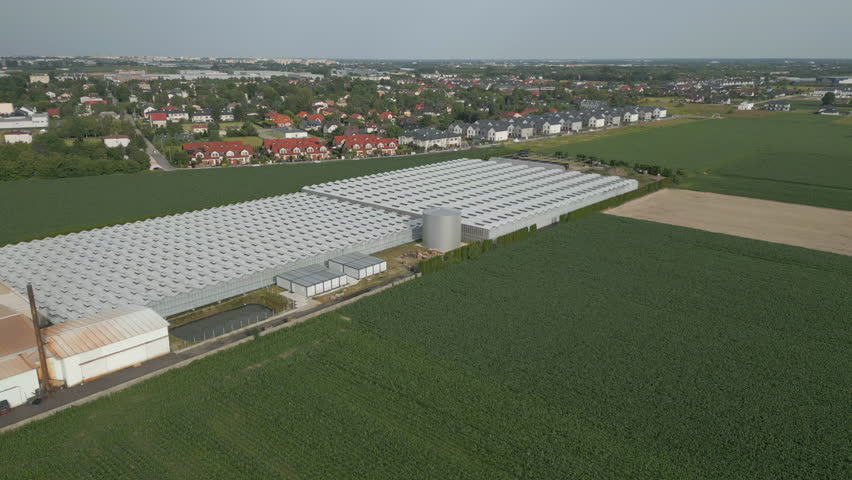Aerial view of suburban greenhouses and crops, agriculture and cultivation under glass.
