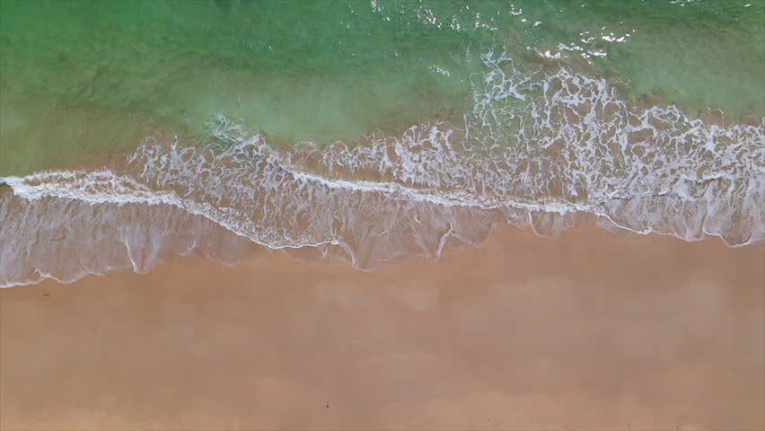 Slow motion sea waves on the sandy beach of Koh Lanta of Krabi province, southern Thailand, Asia.