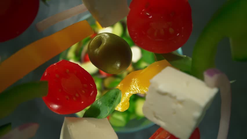 Super Slow Motion Shot of Fresh Salad Ingredients Following by Camera Falling into Bowl at 1000fps.