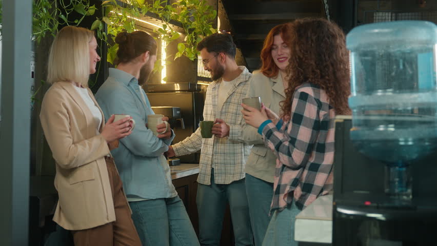 Group diverse freelance business men women male female friends drink coffee eat cookies snacks office break Arabian Caucasian guys girls happy colleagues casual team talk laugh relax drinking in cafe