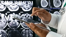 Senior Doctors analyzing Brain x-ray image on Digital Tablet in hospital. A Doctor Diagnosis with patient brain X-ray image scan on Digital Tablet. - Powered by Shutterstock - Get 15% off with code: PIKWIZARD15