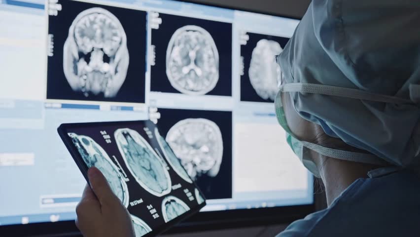 Doctor looking and analyzing a patient's brain X ray on a digital tablet screen. a doctor checking x-rays at digital tablet to examine patient's disease. - Powered by Shutterstock - Get 15% off with code: PIKWIZARD15