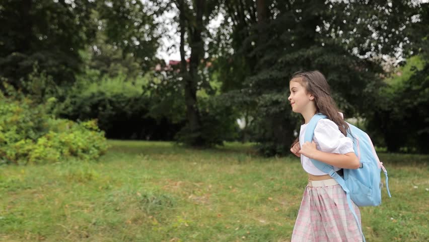 Girl going to the school to study at it after summer vacations. 