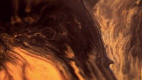 Glitter fluid flow. Sparkling ink. Blur black brown orange golden color mix shimmering dust particles texture paint emulsion wave motion abstract art background. - Powered by Shutterstock - Get 15% off with code: PIKWIZARD15