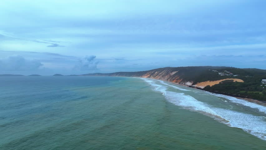 Aerial captures the moody and mysterious atmosphere of the coast running from Rainbow Beach