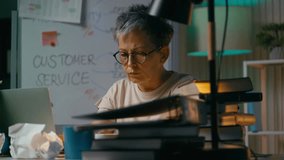 Tired mature female working in office late night, drinking coffee, work overload - Powered by Shutterstock - Get 15% off with code: PIKWIZARD15