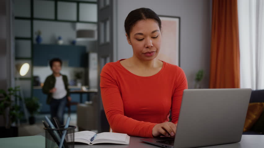 African American woman mother female working business laptop from home distant freelance work little son boy kid child hugging embracing cuddling mom love cute cuddle family bonding hugging childcare