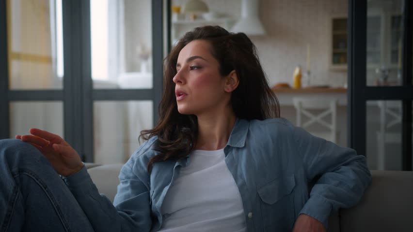 Overheated Caucasian woman on sofa couch wave hand refresh tired cool with arms unhappy sweaty lady girl female suffer of high temperature problem feel sweat at hot living room without air conditioner