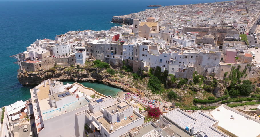 Town And The Lama Monachile Beach In Polignano a Mare, Apulia Region, Italy - Aerial Drone Shot