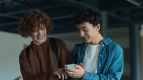 University back to school Caucasian two boys teens pupils students people guys male friends talking smiling laughing talk using mobile phone surprise shocked excited walk studying education teenagers - Powered by Shutterstock - Get 15% off with code: PIKWIZARD15