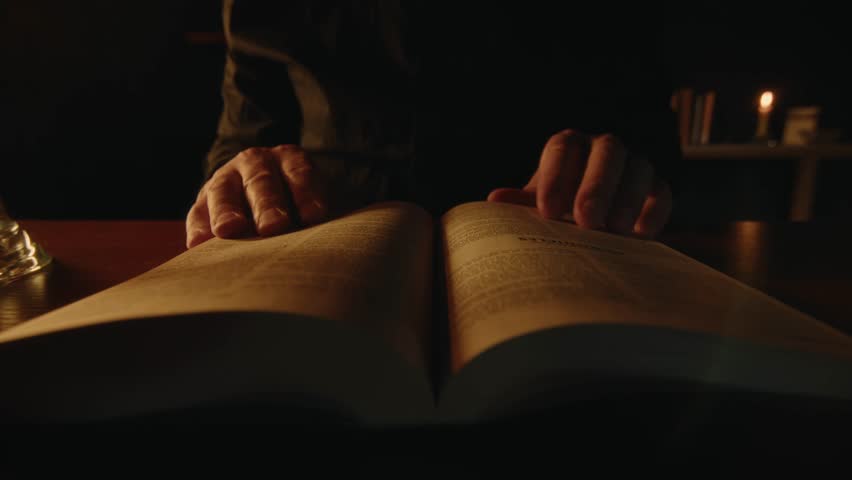 A believer is reading the Bible in the evening, researching the holy scripture in soft candle light, spiritual practice, Middle shot, High quality 4k footage