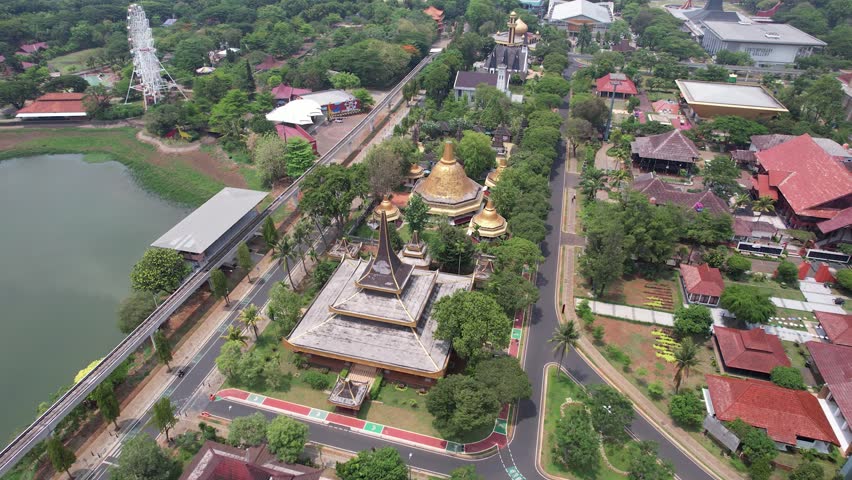  Experience the breathtaking aerial views of Taman Mini Indonesia Indah (TMII) in Jakarta, Indonesia. This drone footage captures the vast cultural and recreational park, showcasing its stunning lands