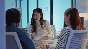 group of Happy young asian business people chatting happily after a night of overtime work in the office.Supervisor chats with employees after working together planning success strategy enjoy teamwork - Powered by Shutterstock - Get 15% off with code: PIKWIZARD15