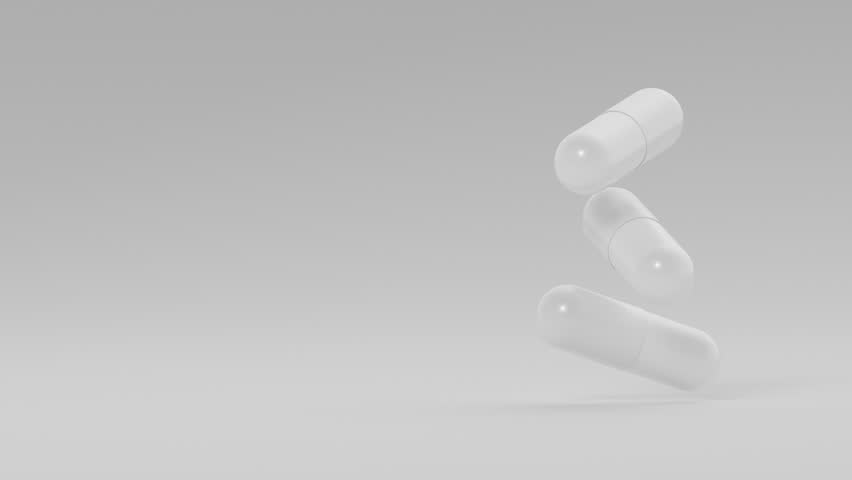Animation of white medicine capsules rotating against white backdrop. Medical research, science concept. 3d render animation loopable