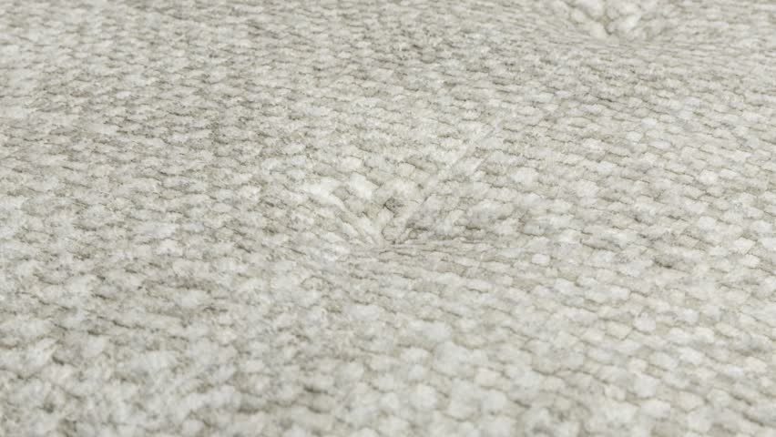 Camera slowly zooms in on fluffy wool texture on seat cushion in photography studio