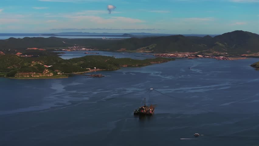 Ela Beach Port Moresby Papa Papua New Guinea Aerial drone oil rig boat blue sky stunning sunny morning bay coastline hills PNG Capital City fishing wharf Harbor Idlers Bay circle left