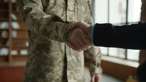 Unknown Caucasian male officer camouflage uniform guy man military army soldier veteran handshake arms psychologist businessman inside office cabinet psychology support healthcare war hero army forces - Powered by Shutterstock - Get 15% off with code: PIKWIZARD15