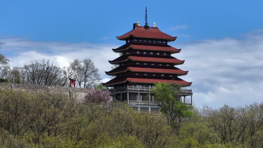The Pagoda Building on Mount Penn Top during sunny day in Reading, PA, USA. Spring Season with Asian architecture. Aerial zoom approaching shot.