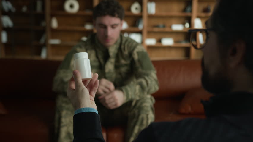 Unrecognizable psychologist therapist hands holding medical drug drops jar pills talk discuss recommending Caucasian man uniform male guy military soldier mental health treatment patient prescription