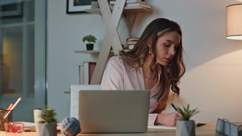 Shocked manager reading notification email in night office. Closeup upset woman working laptop receiving bad news. Frustrated stressed businesswoman closing computer thinking problem solution at desk.