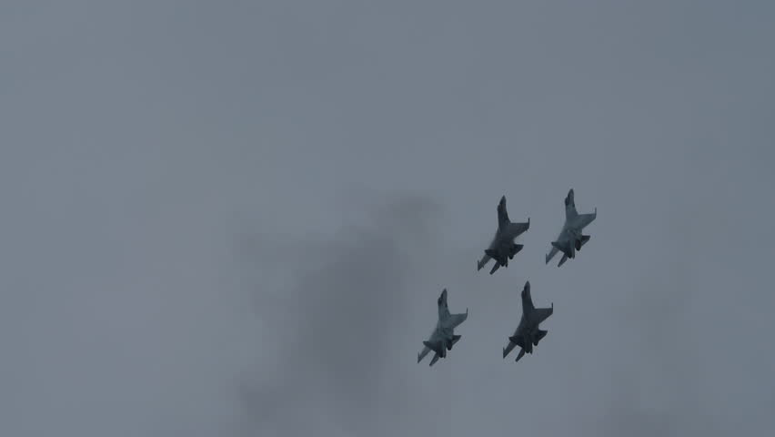 Group military fighter jets are flying high in the sky. Silhouette of a bomber. Concept war, army