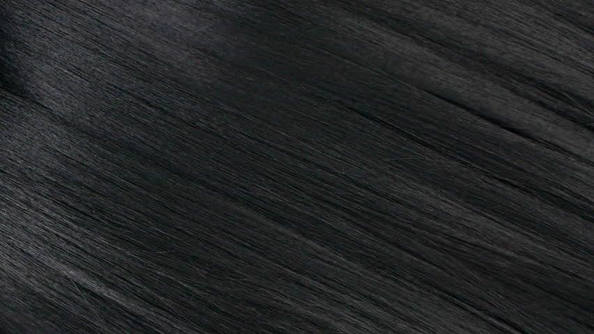 Closeup human long hair texture in slow motion, black straight hair background