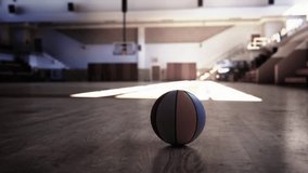 A basketball is seen stationary on the wooden floor of an old gym. - Powered by Shutterstock - Get 15% off with code: PIKWIZARD15