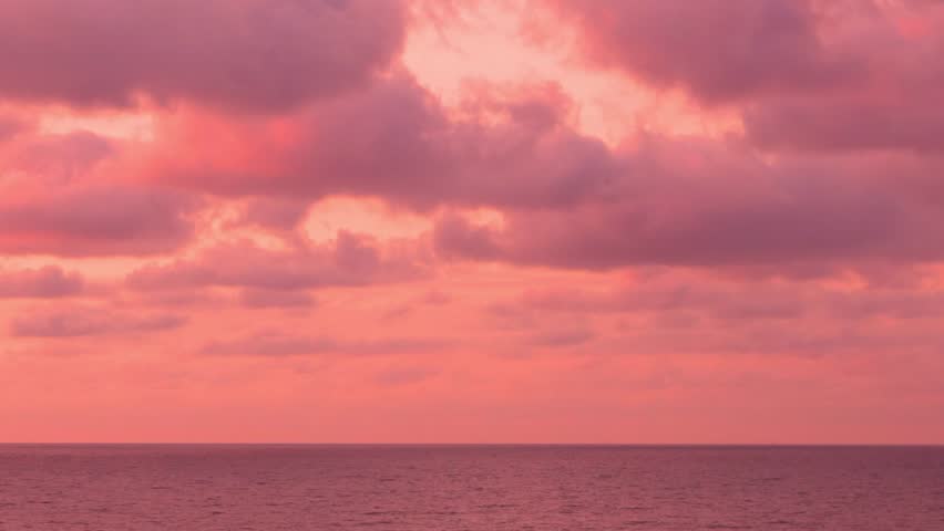 Beautiful Aerial View Sea and Red Coral Lilac Pink Sunset Colorful Puffy Clouds Sky Sun Time Lapse, Motion. Delightful Evening Sky with Colored Clouds and Ocean, Background, Travel, Planet, Relax.