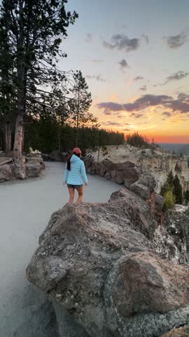 Young Woman on Viewpoint at Sunset, Grand Canyon of Yellowstone National Park, Wyoming USA