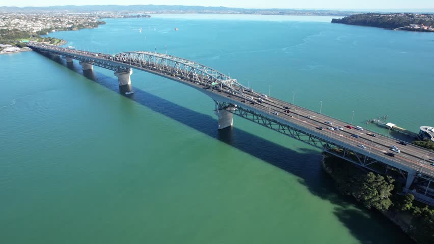 Traffic On Auckland Harbour Bridge Over The Waitemata Harbour In Auckland, New Zealand. Aerial Shot