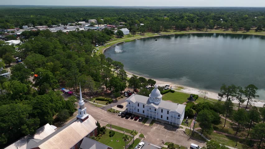 Chautauqua Building On Shore Of Lake DeFuniak With Hydroflight Activity In Summer. DeFuniak Springs, Florida. aerial shot