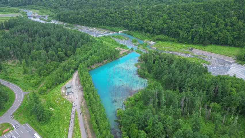 Biei, Hokkaido: Aerial drone footage of the famous Shirogane Blue Pond near Asahikawa in Central Hokkaido in Japan in summer. 