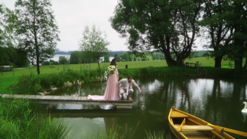 The groom kisses the bride in a beautiful romantic place. the bride and groom kiss against the background of beautiful nature. wedding event. blur