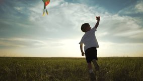 Happy Child running with in wind. Joyful child playing with kite. Happy kid flying colorful kite in blue sky. Happy Child enjoying windy day with kite. Outdoor fun with kite. Child carefree moment. - Powered by Shutterstock - Get 15% off with code: PIKWIZARD15