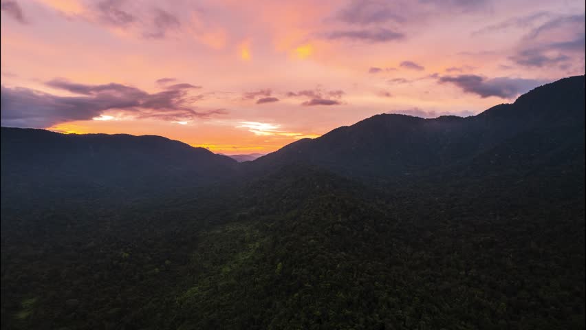 Aerial view of majestic mountains at sunset in lush forest, Babinda, Queensland, Australia.
