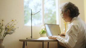 Asian senior mature woman using laptop computer with internet for e-Learning study or business work on desk at home. Elderly people smart life with wireless technology and digital gadget device. - Powered by Shutterstock - Get 15% off with code: PIKWIZARD15