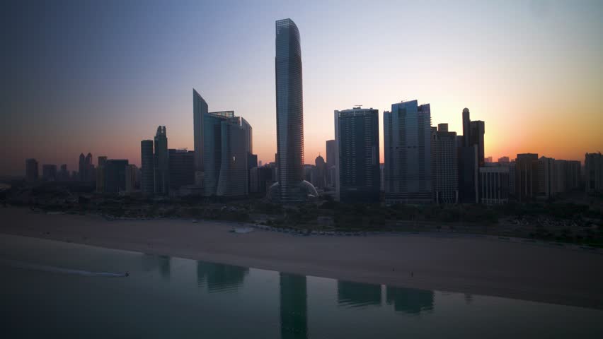 Aerial view of Abu Dhabi skyline at sunset, United Arab Emirates.